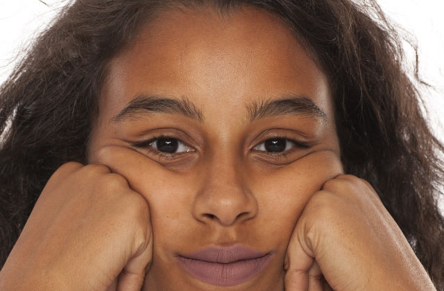 Dark skin woman with tired eyes